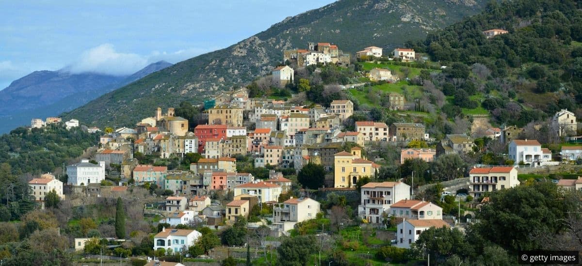 hillside enclaves along the coast of corsica in france