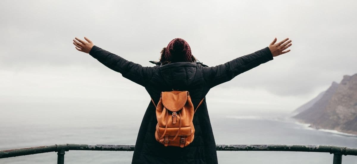 woman standing on the edge of the sea enjoying experience