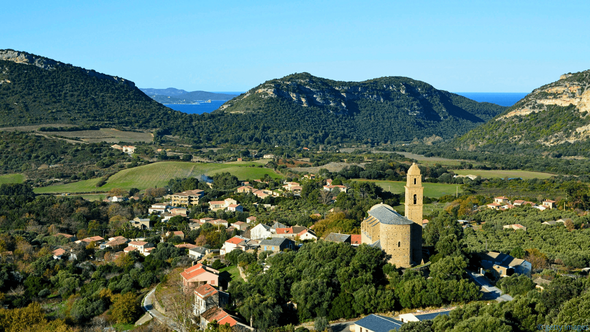 the island of corsica and a small town on the sea