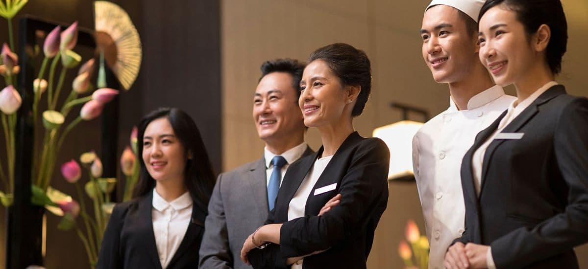 hotel employees gather for their preshift meeting