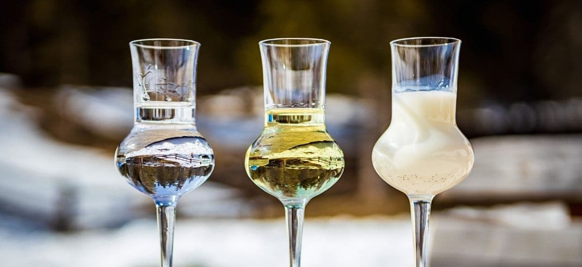different styles of grappa being served in traditional grappa glassware