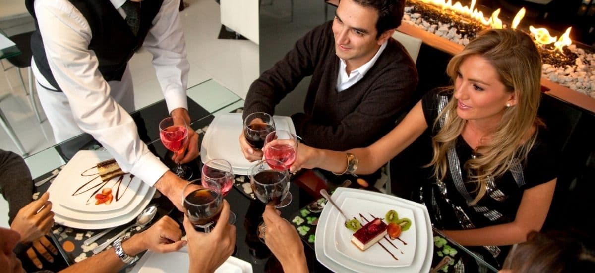 guests in a luxury restaurant environment being served cocktails