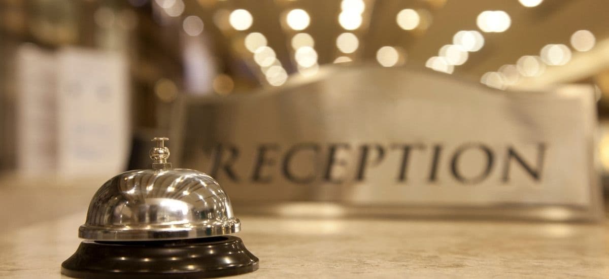 the reception desk in a luxury hotel managed by hospitality professionals