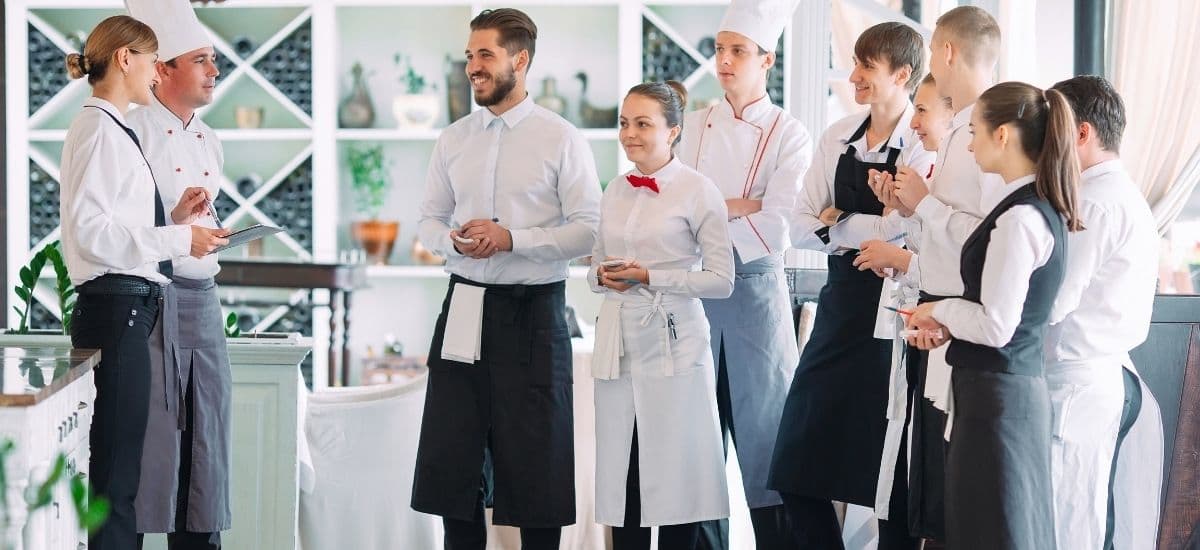hospitality employees meeting before their dinner rush takes place