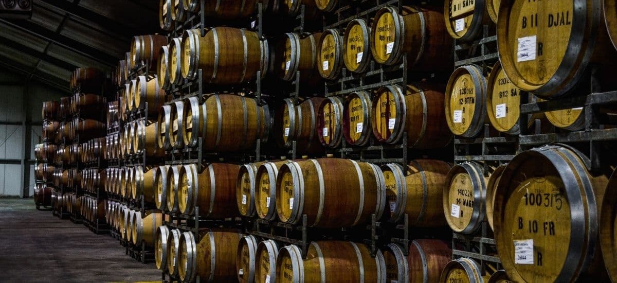 massive amounts of wine in storage in stacked barrels