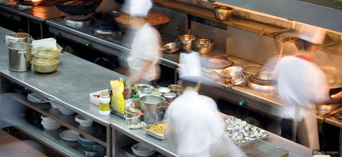 a busy restaurant scene in the kitchen