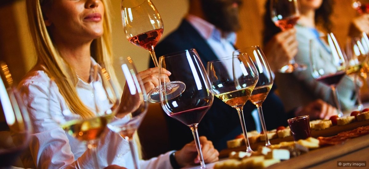 A sommelier engaging with guests at a restaurant table