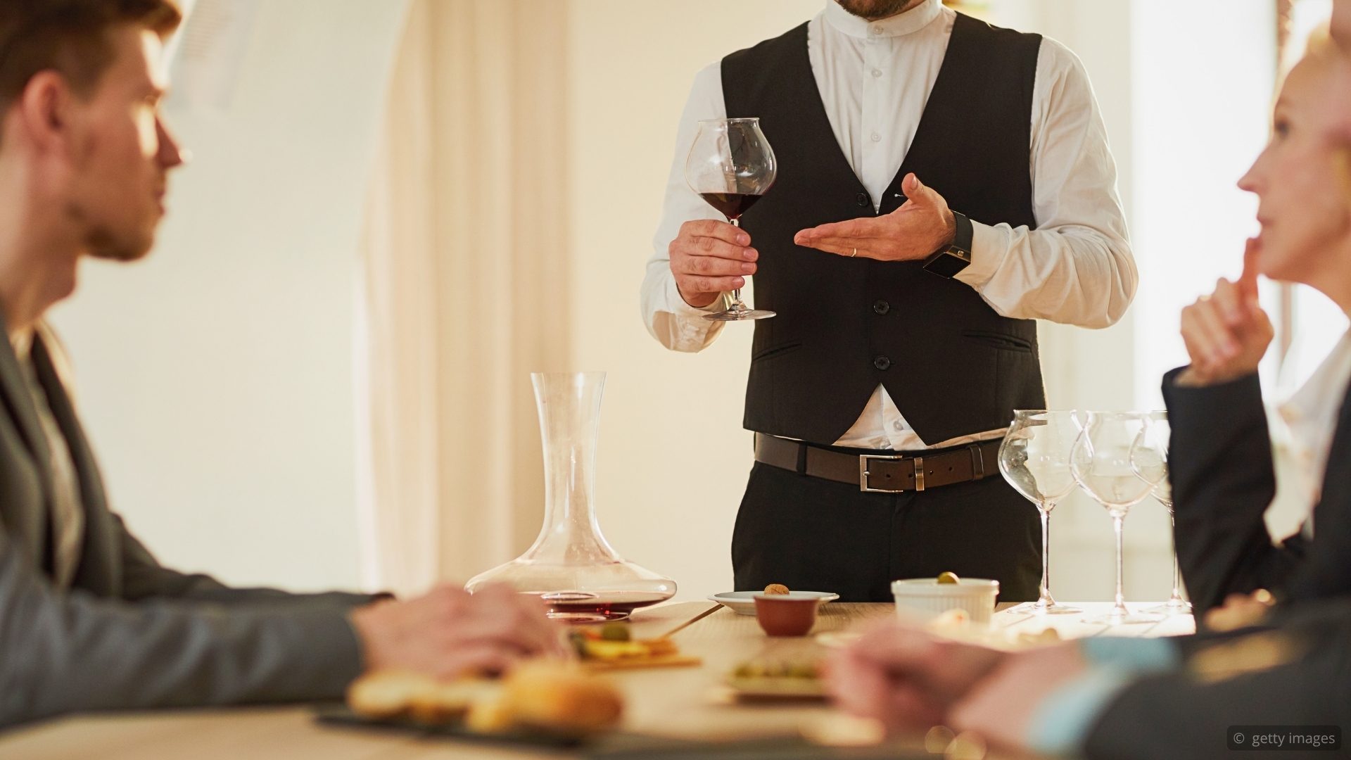 The Sommelier Position course, featuring a sommelier presenting wine tableside