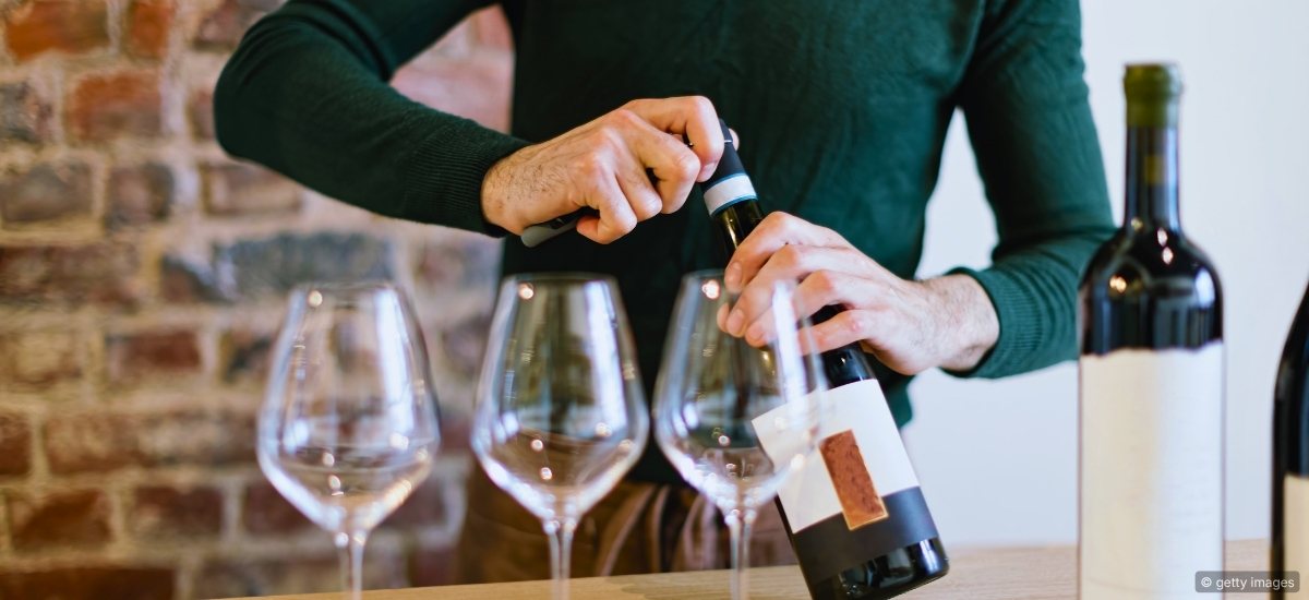 A sommelier reviewing wine inventory and pricing in a cellar